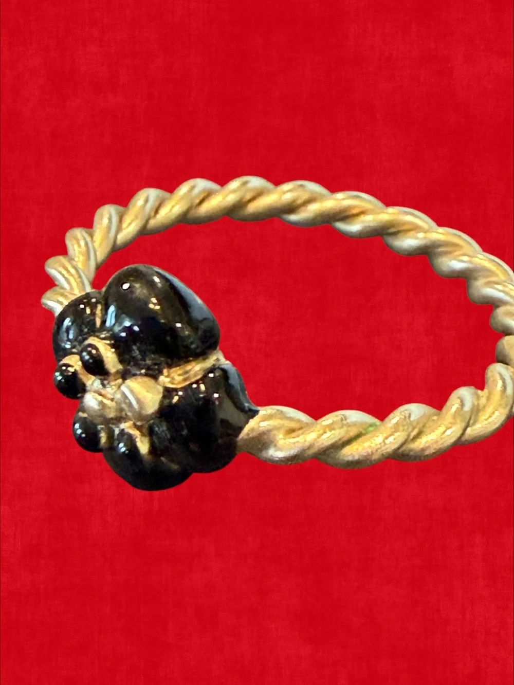 CHANEL Gold-Tone Twisted Band Ring with Black Floral Motif